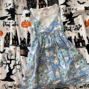 A dress with blue and white flowers. It has no rips or holes and is a 7/8 girls.